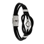 Brazalete de tiras de cuero negro fino con abalorio esférico y terminales de acero inoxidable."